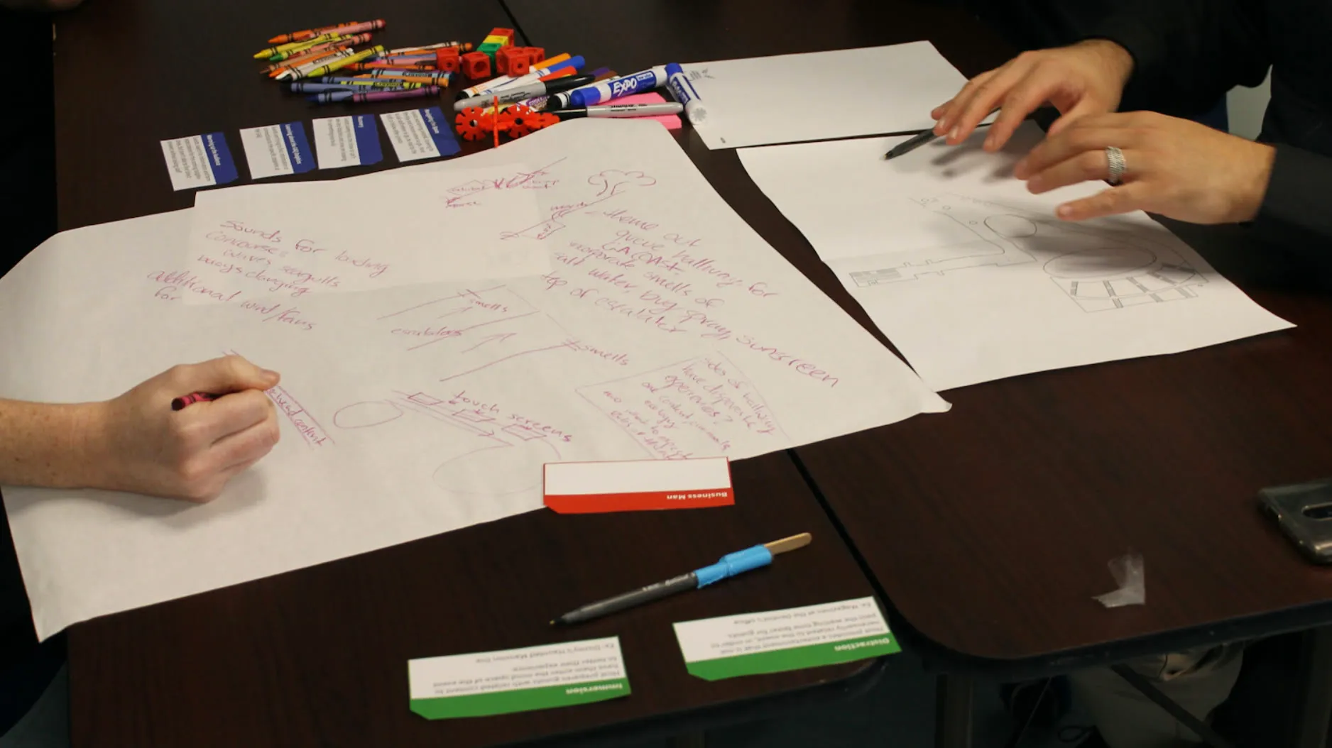 Aquarium stakeholders sketching concepts during a participatory design workshop