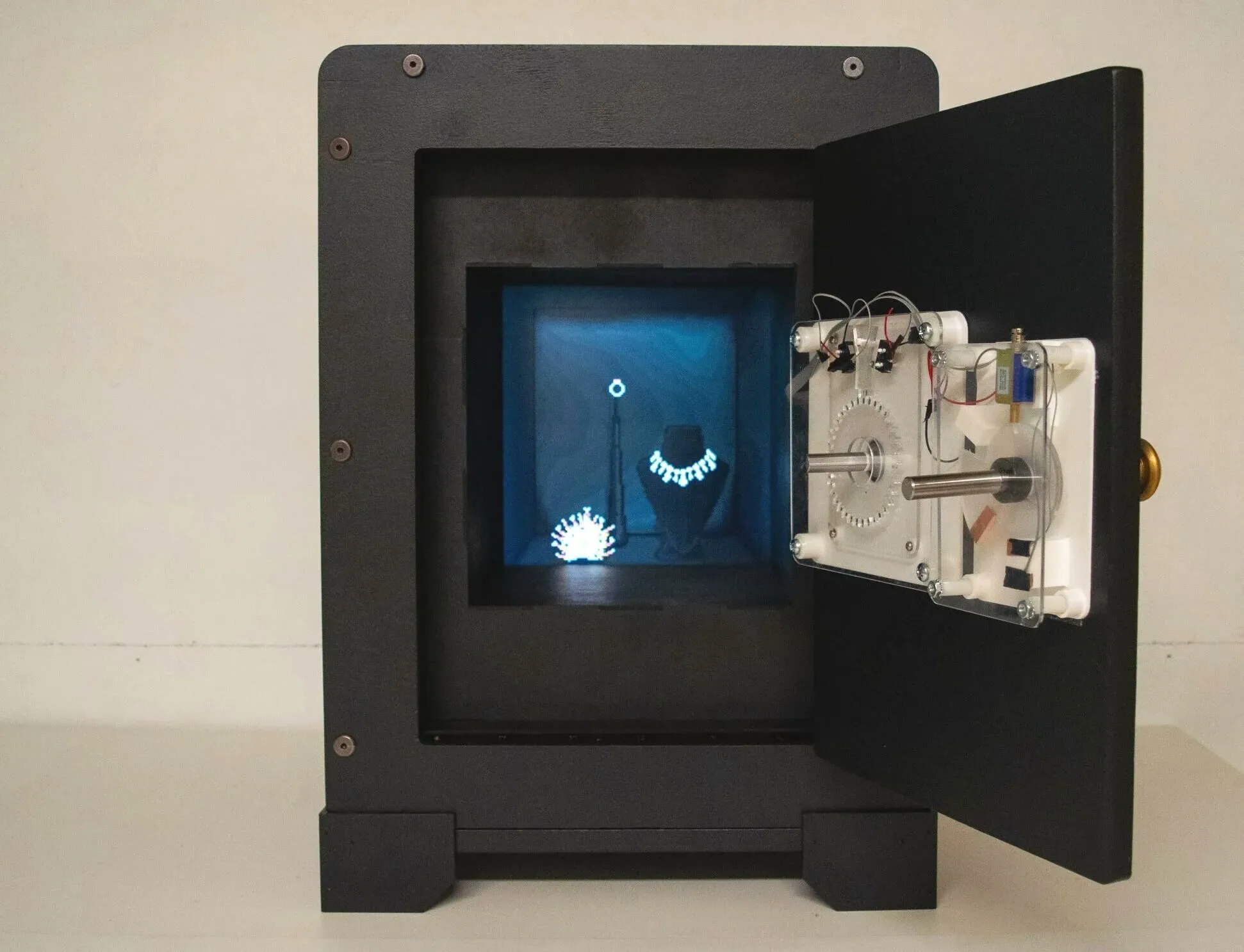 The safe open, showing its internals and the lit inner display